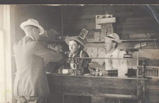 Three men at a counter in a Kelliher business